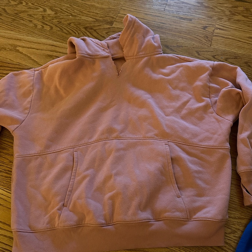 pink sweatshirt. little cut v